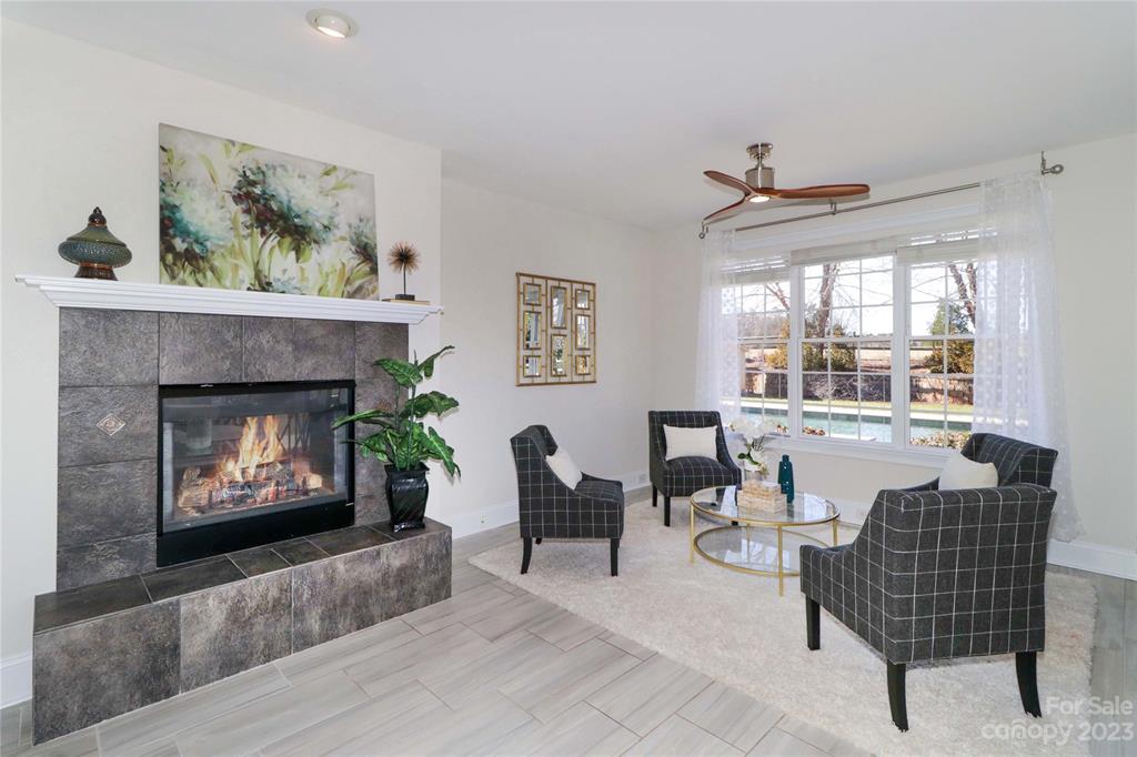 120 Sink Farm Road Mooresville, NC 28115 - Photo 14 of 46 a living room with furniture a fireplace and a large window