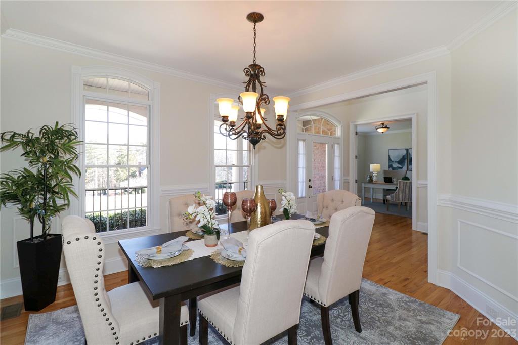 120 Sink Farm Road Mooresville, NC 28115 - Photo 20 of 46 a dining room with furniture a chandelier and wooden floor