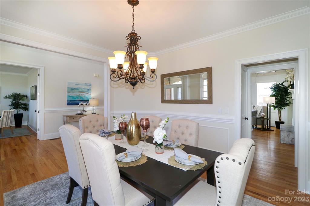 120 Sink Farm Road Mooresville, NC 28115 - Photo 22 of 46 a view of a dining room and livingroom with furniture wooden floor a chandelier