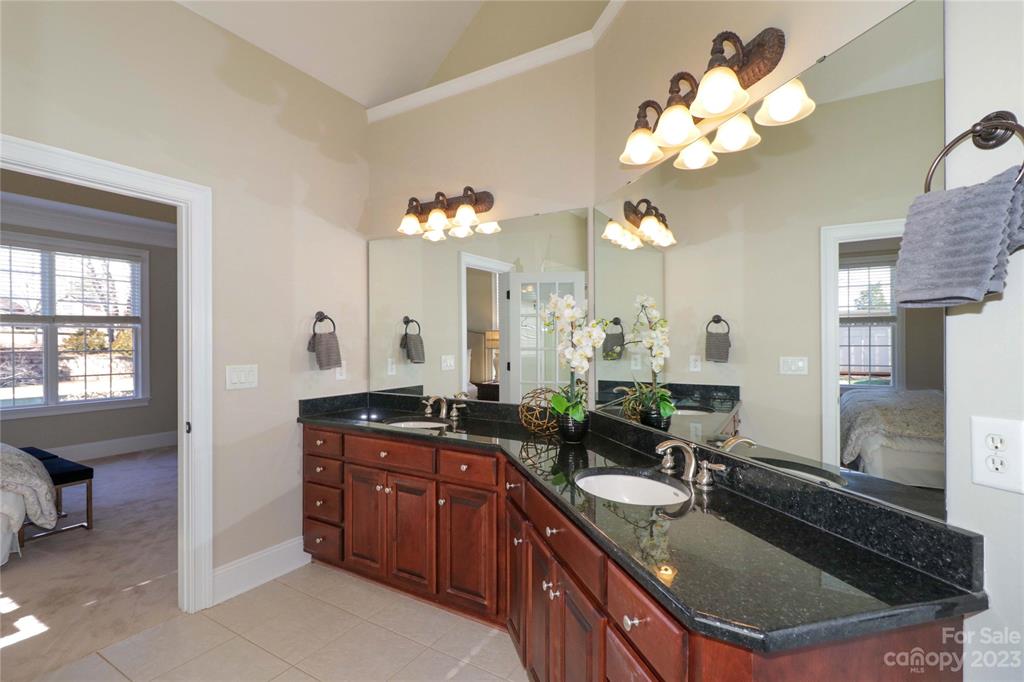 120 Sink Farm Road Mooresville, NC 28115 - Photo 30 of 46 a bathroom with a granite countertop sink a large mirror and a bathtub