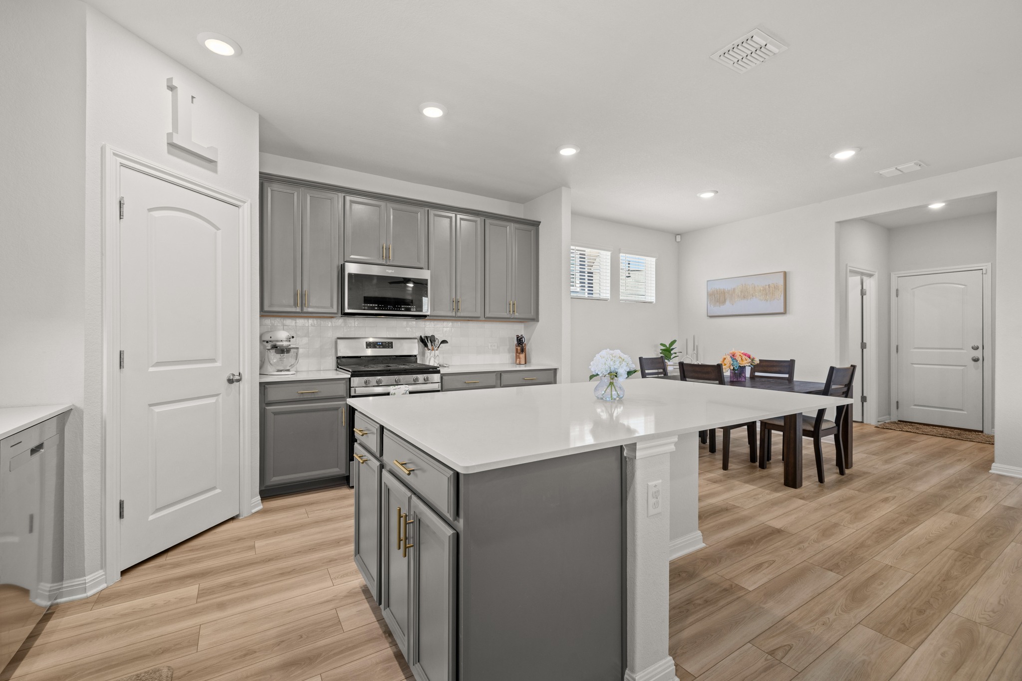 2049 Winston Way Leander, TX 78641 - Photo 8 of 35 The oversized island with gleaming Silestone countertops is the perfect place for family and friends to gather.
