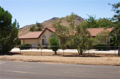 19688 Corwin Road Apple Valley, CA 92307 - Photo 1 of 1 a view of a white house with a snow on the road