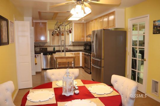 1624 South Farragut Street Ridgecrest, CA 93555 - Photo 9 of 43 a living room with stainless steel appliances furniture a rug and a chandelier