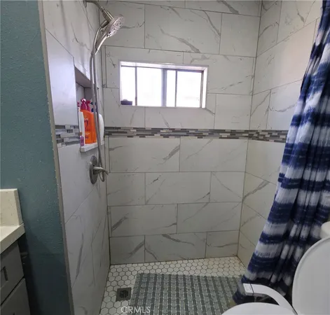 a bathroom with a toilet and a shower
