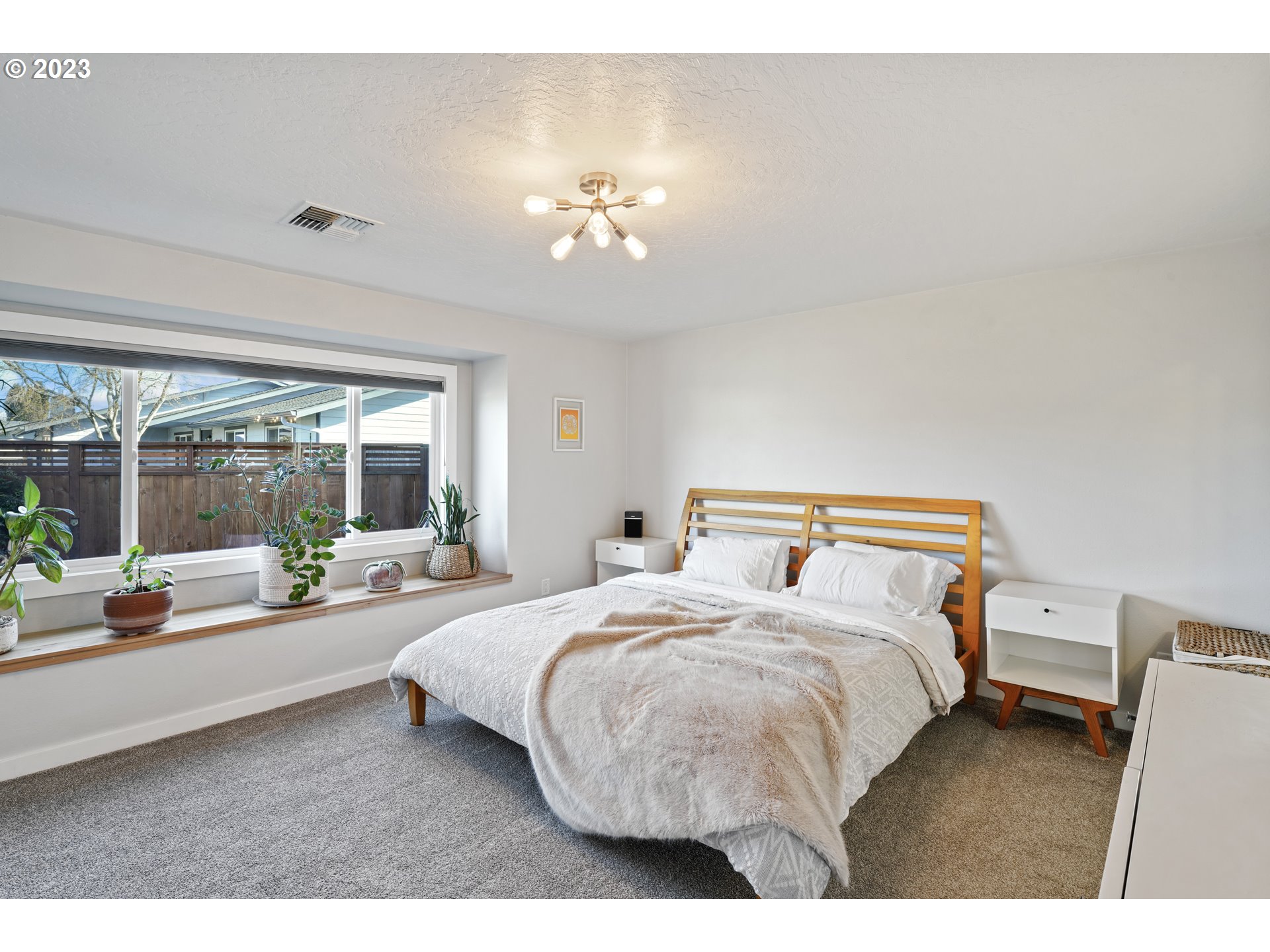 2180 9th Street Springfield, OR 97477 - Photo 15 of 32 a bedroom with a bed and a large window