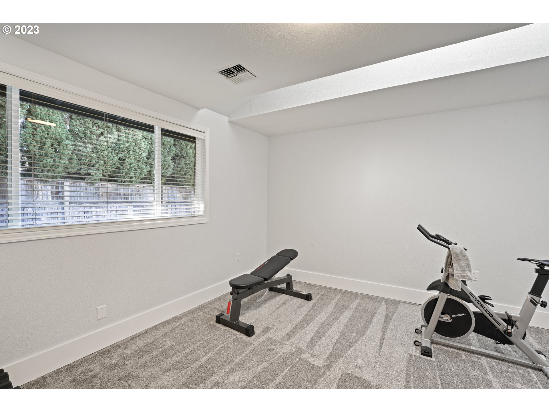 2180 9th Street Springfield, OR 97477 - Photo 20 of 32 a room with gym equipment on wooden floor and a window