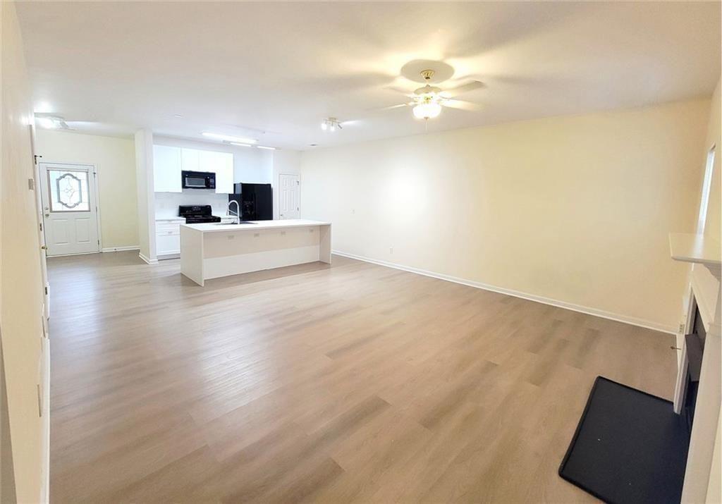 1516 Parc Main Street Lawrenceville, GA 30046 - Photo 1 of 16 a view of kitchen and hall with wooden floor