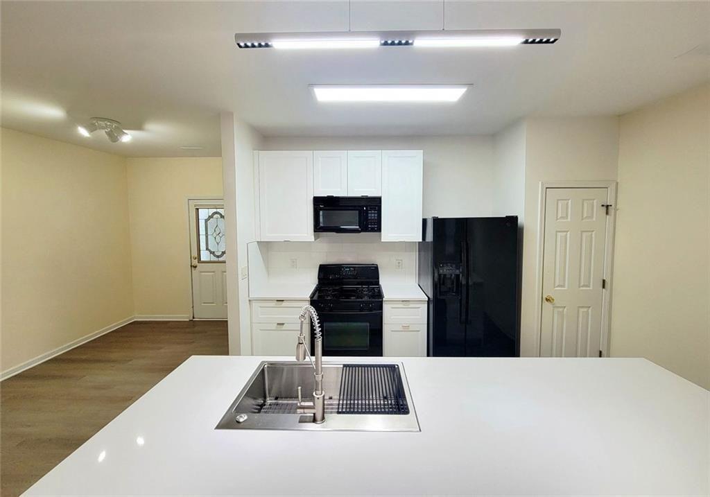 1516 Parc Main Street Lawrenceville, GA 30046 - Photo 4 of 16 a kitchen with a refrigerator and a stove top oven