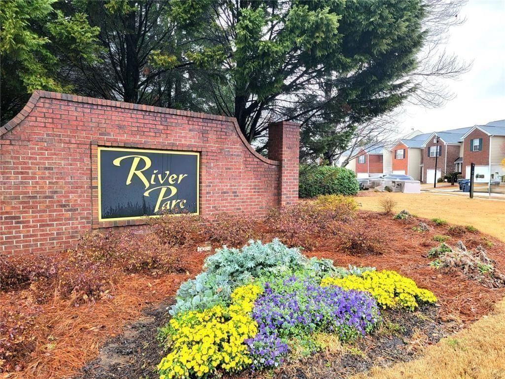 1516 Parc Main Street Lawrenceville, GA 30046 - Photo 6 of 16 a sign that is in front of flowers
