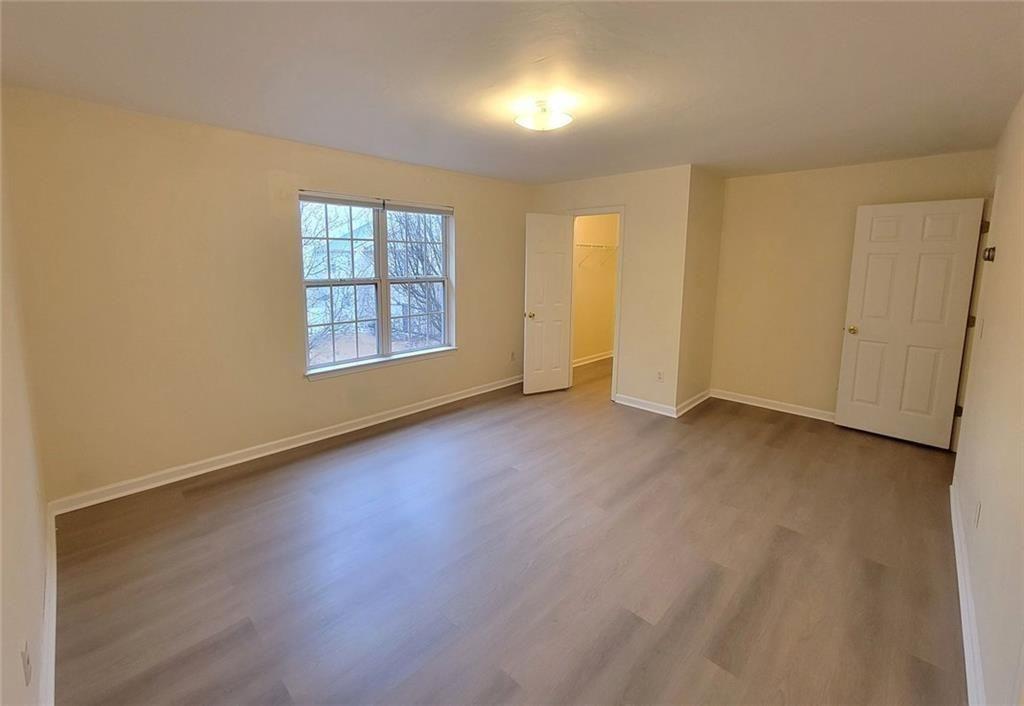 1516 Parc Main Street Lawrenceville, GA 30046 - Photo 9 of 16 an empty room with wooden floor and windows