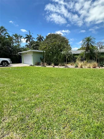 a view of a house with a yard and a garden