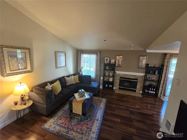 a living room with furniture a fireplace and a flat screen tv