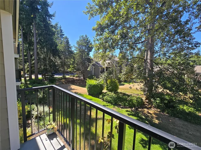 a view of balcony with wooden floor and trees