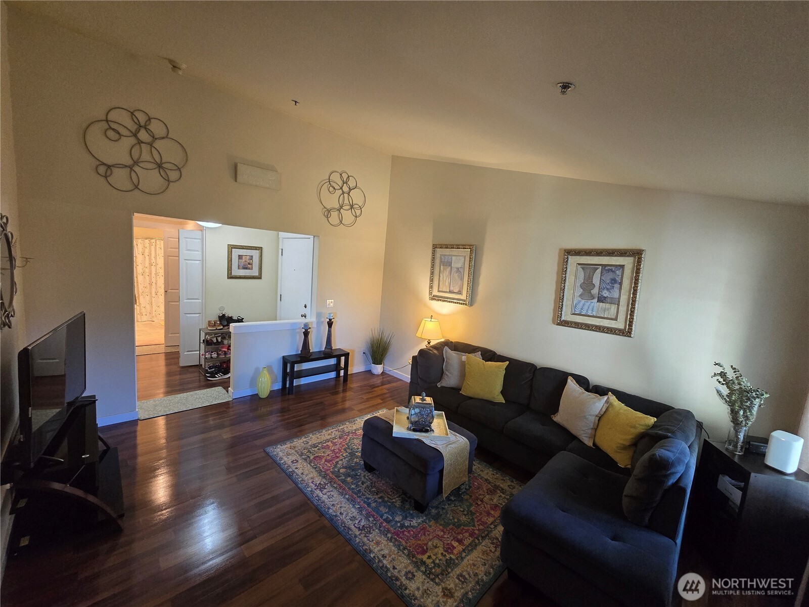 1840 South 284th Lane, Unit H204 Federal Way, WA 98003 - Photo 2 of 14 a living room with furniture and a flat screen tv