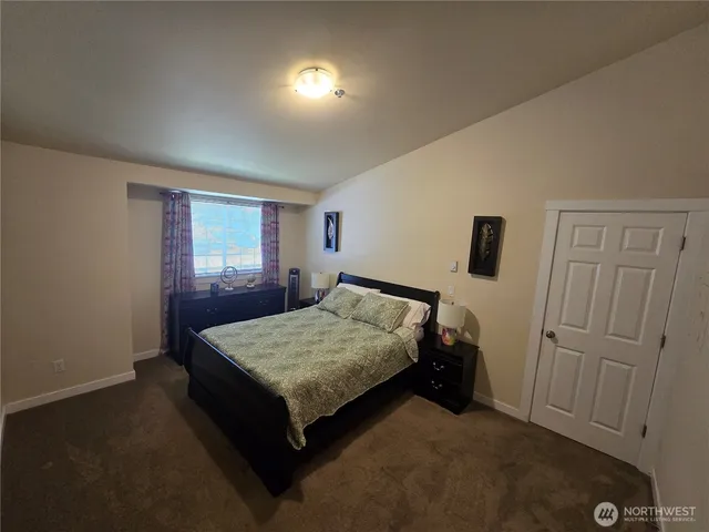 a bed room with a bed and a window