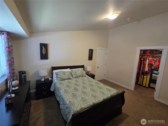 a bedroom with a bed and a view of bathroom