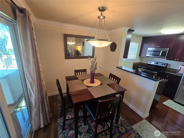 a view of a dining room with furniture and wooden floor