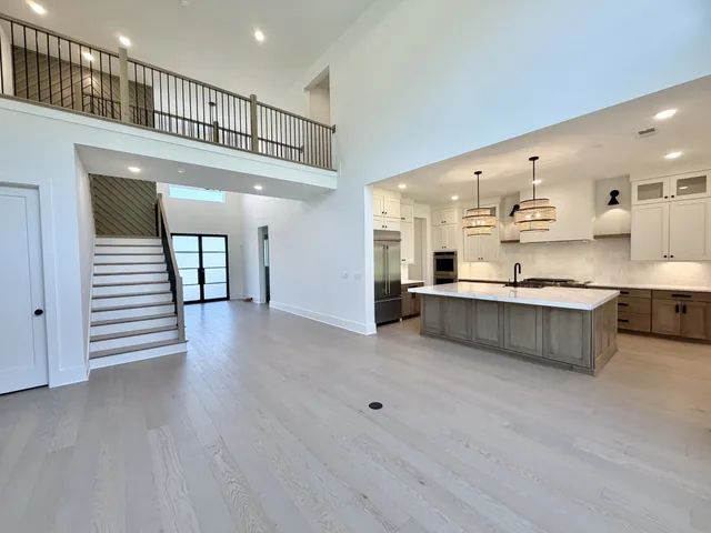 a kitchen with stainless steel appliances granite countertop a sink a oven and a refrigerator