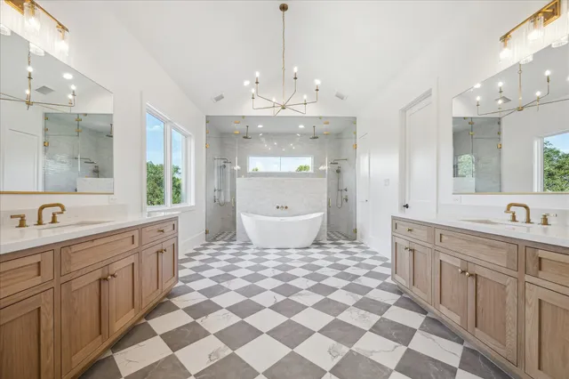 a spacious bathroom with a double vanity sink mirror and a bathtub