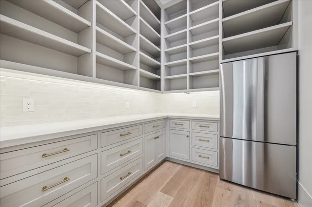 a kitchen with cabinets and a refrigerator
