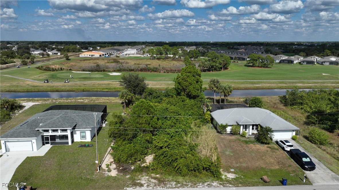 105 Paddock Street Lehigh Acres, FL 33974 - Photo 14 of 20 a view of a swimming pool with an outdoor space and seating area