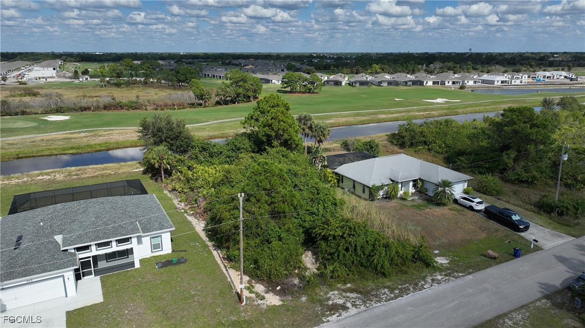 105 Paddock Street Lehigh Acres, FL 33974 - Photo 15 of 20 an aerial view of a house with a yard and lake view