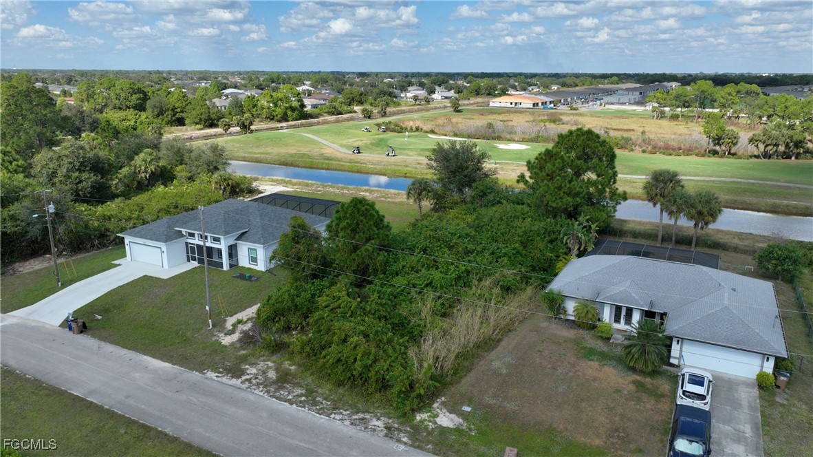 105 Paddock Street Lehigh Acres, FL 33974 - Photo 16 of 20 an aerial view of residential houses with outdoor space and lake view
