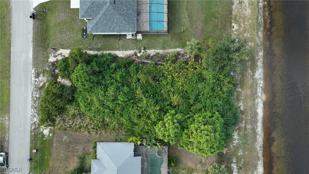 105 Paddock Street Lehigh Acres, FL 33974 - Photo 17 of 20 an aerial view of a house with a yard