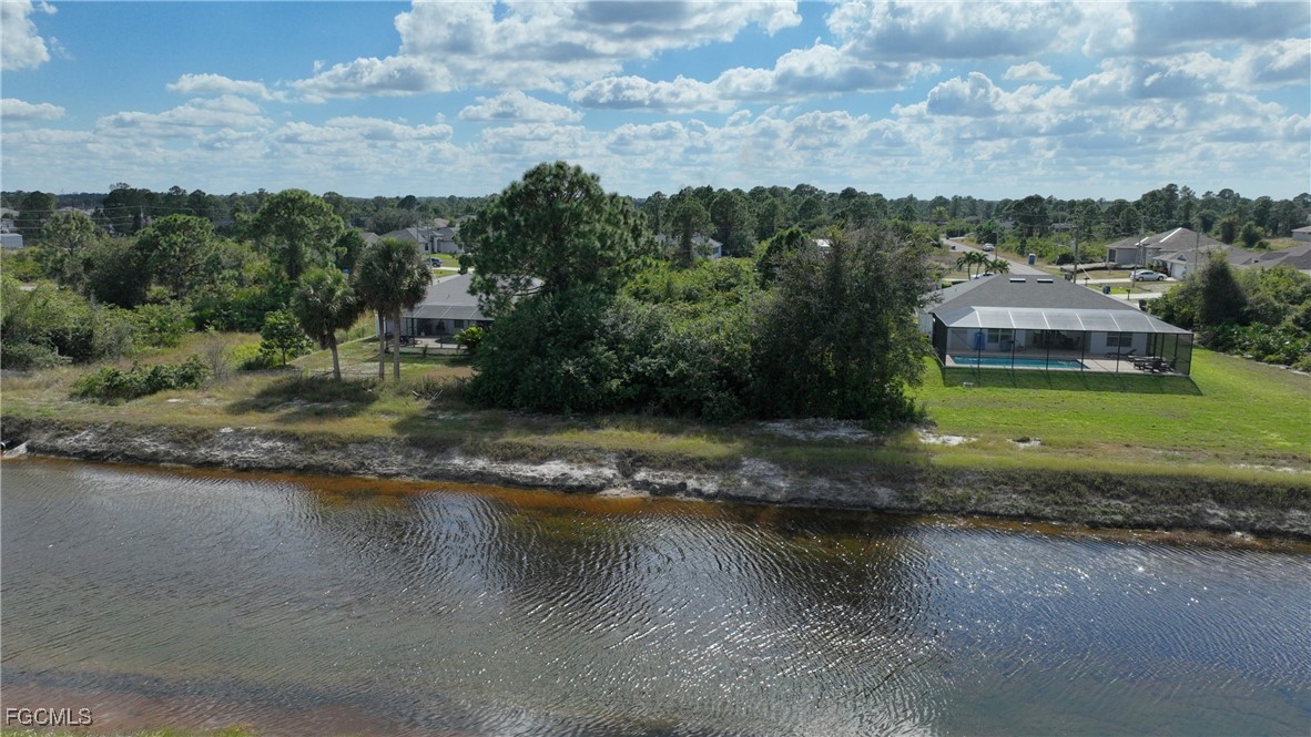 105 Paddock Street Lehigh Acres, FL 33974 - Photo 6 of 20 an aerial view of a house with a yard and lake view