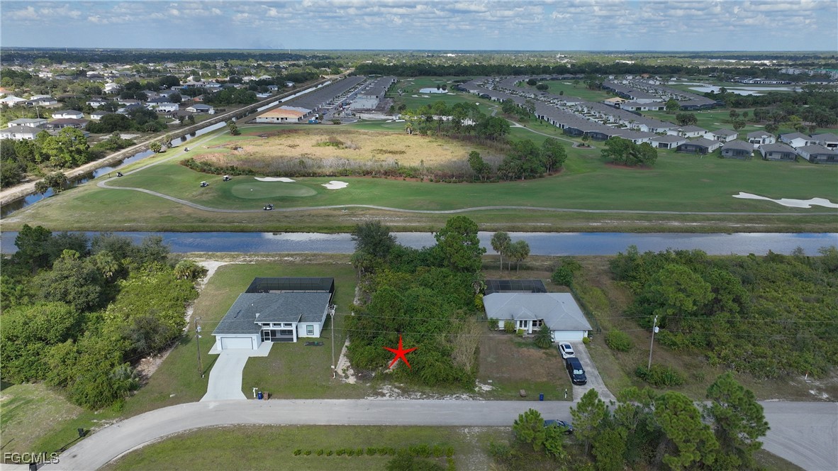 105 Paddock Street Lehigh Acres, FL 33974 - Photo 8 of 20 an aerial view of a house with a yard