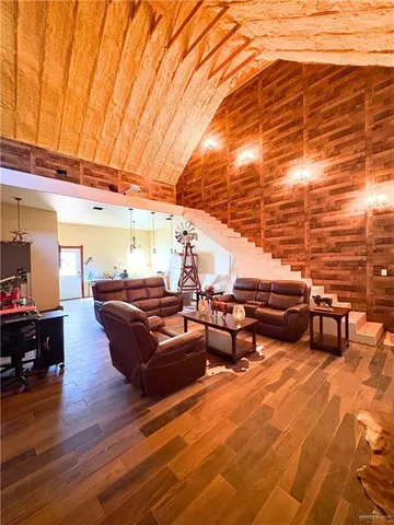 a living room with patio furniture and wooden floor