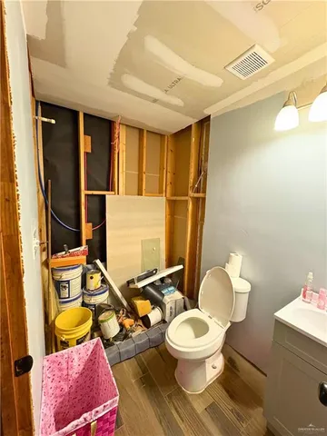 a bathroom with a toilet sink and mirror