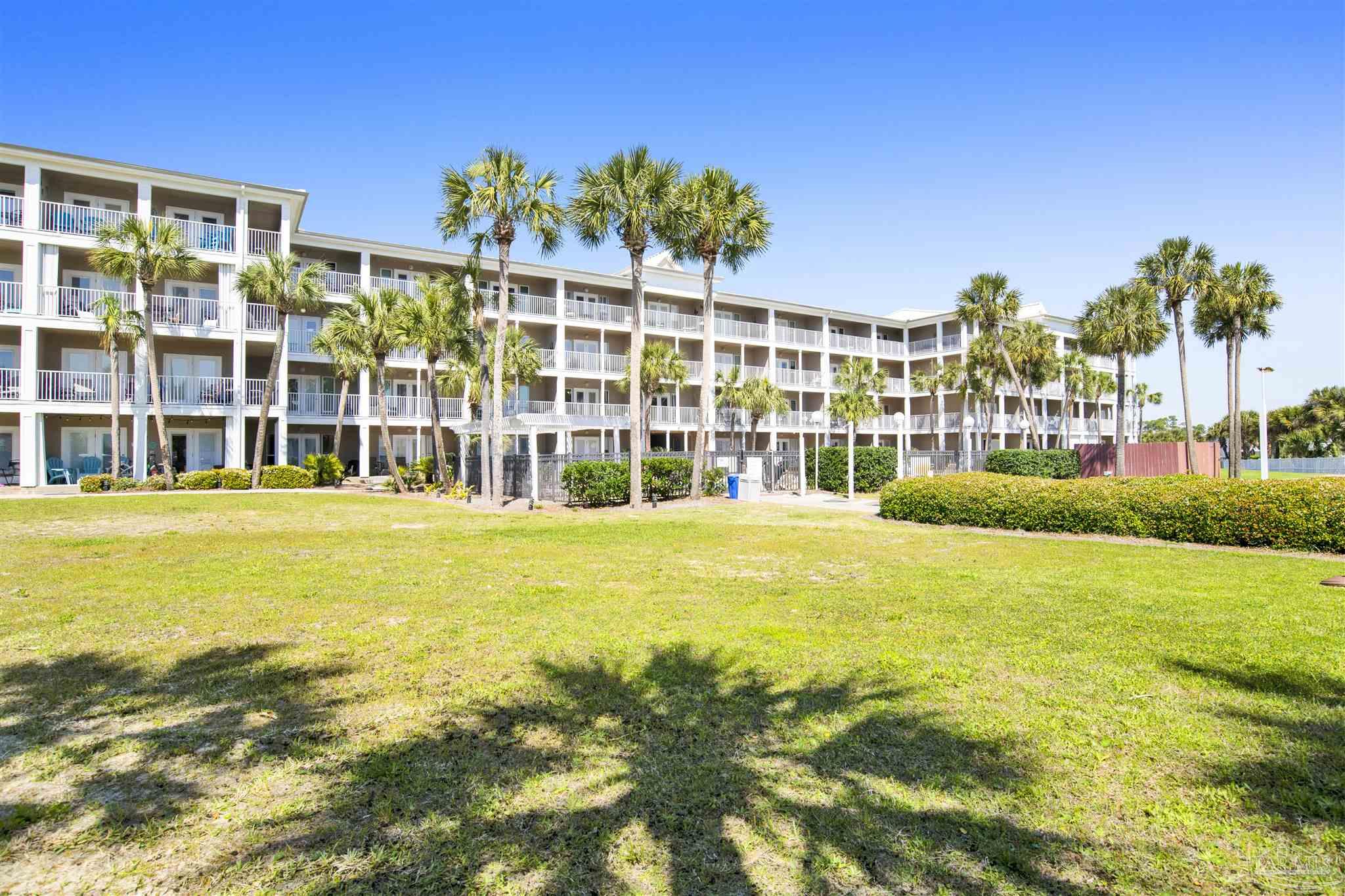 13351 Johnson Beach Road, Unit 203E Perdido Key, FL 32507 - Photo 43 of 55 a view of an ocean with a swimming pool and large trees