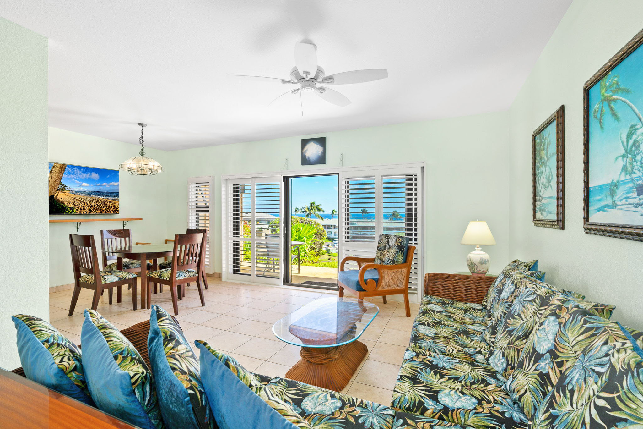 1568 Pe'e Road, Unit 211 Koloa, HI 96756 - Photo 11 of 30 a living room with furniture a chandelier and a dining table