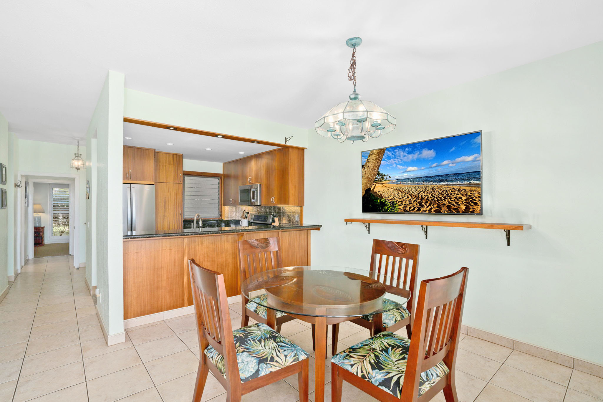 1568 Pe'e Road, Unit 211 Koloa, HI 96756 - Photo 12 of 30 a view of a dining room with furniture and chandelier
