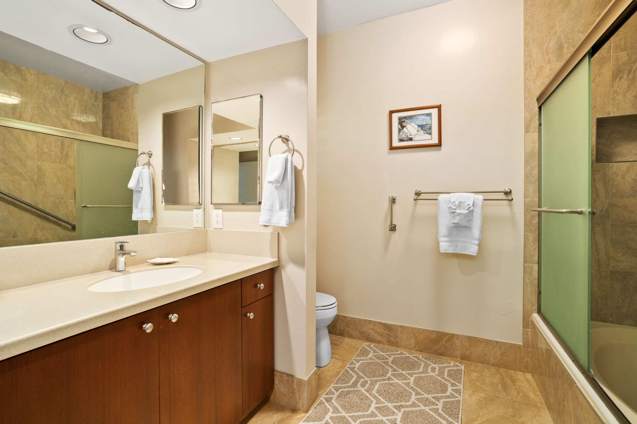 1568 Pe'e Road, Unit 211 Koloa, HI 96756 - Photo 16 of 30 a bathroom with a double vanity sink toilet and shower