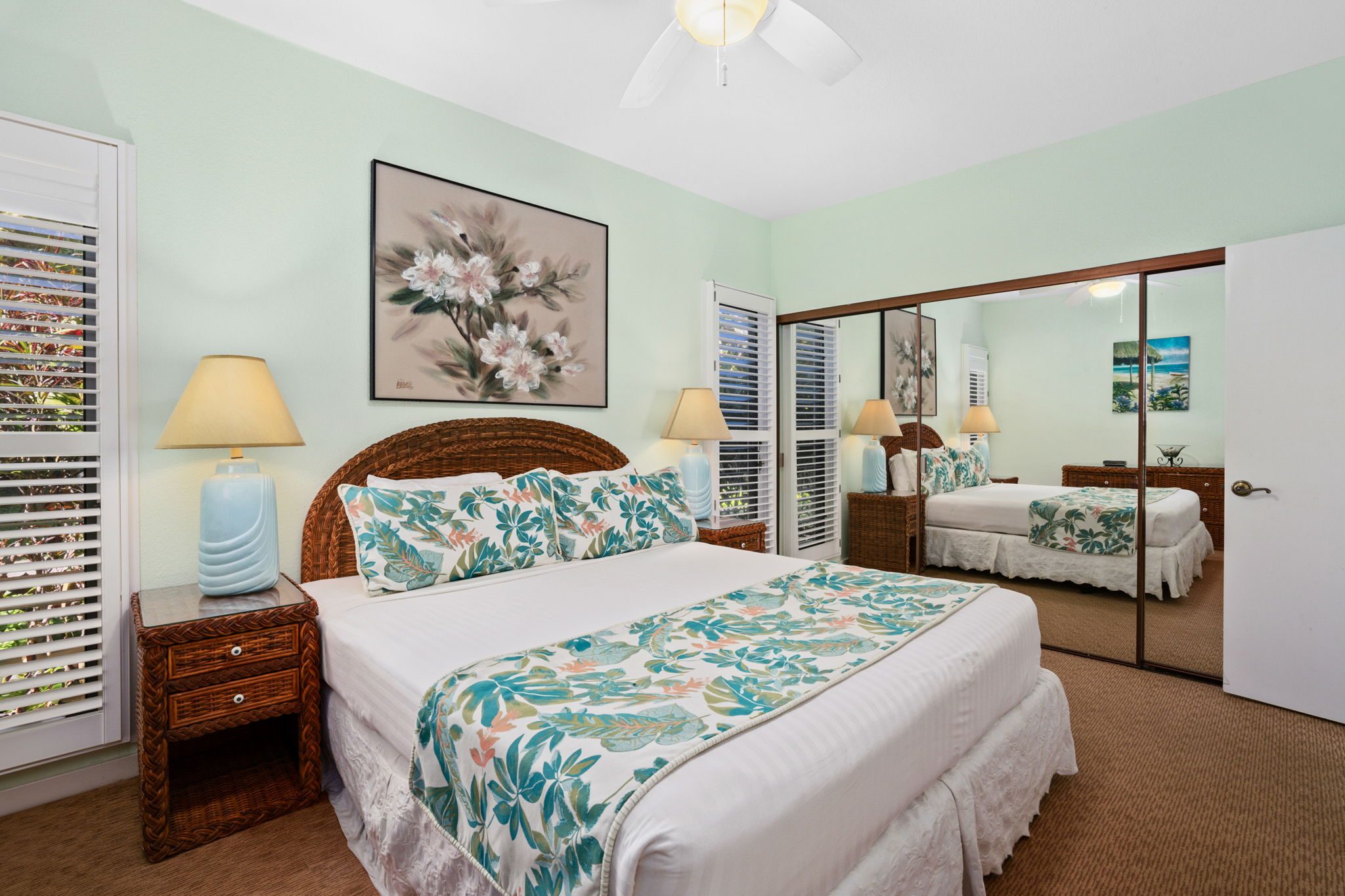 1568 Pe'e Road, Unit 211 Koloa, HI 96756 - Photo 20 of 30 a bedroom with a large bed and a painting on the wall