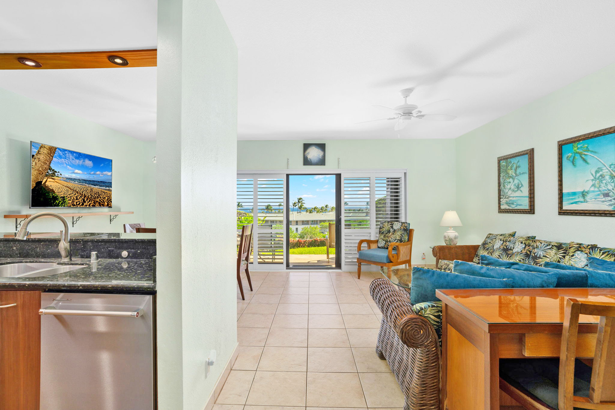 1568 Pe'e Road, Unit 211 Koloa, HI 96756 - Photo 9 of 30 a living room with blue lights with furniture and kitchen view