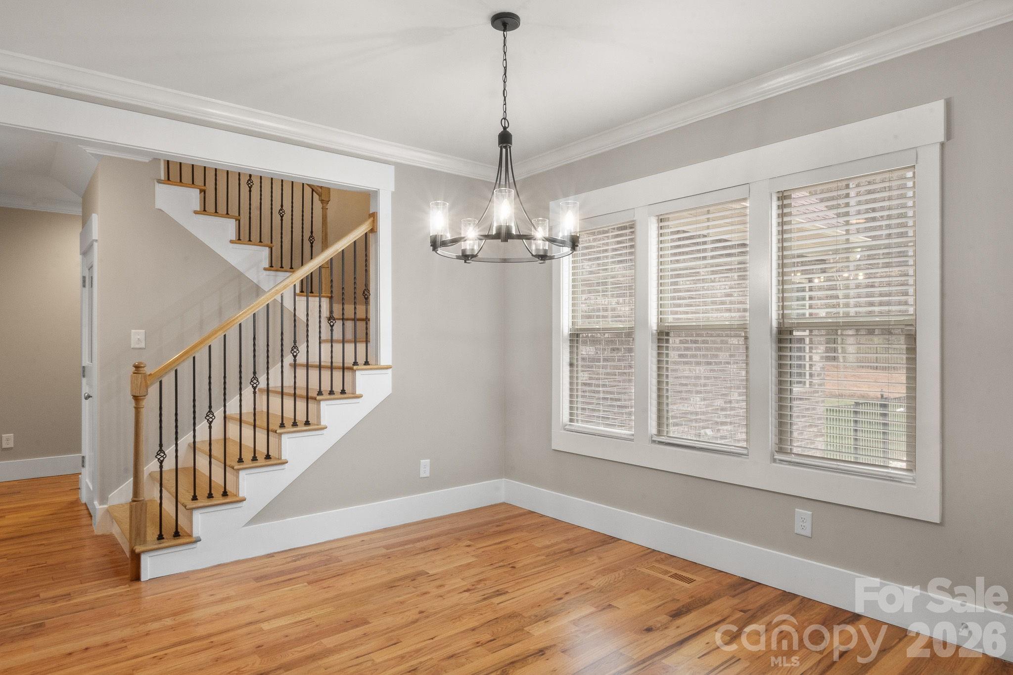 7261 Bay Ridge Drive Denver, NC 28037 - Photo 21 of 48 a view of an empty room with wooden floor and a window
