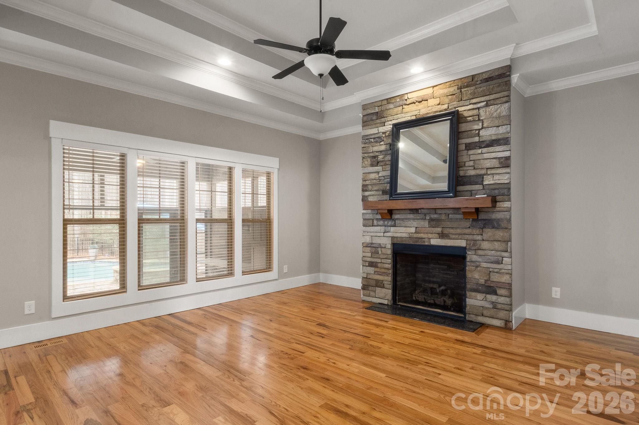 7261 Bay Ridge Drive Denver, NC 28037 - Photo 24 of 48 a view of an empty room with wooden floor fireplace and a window