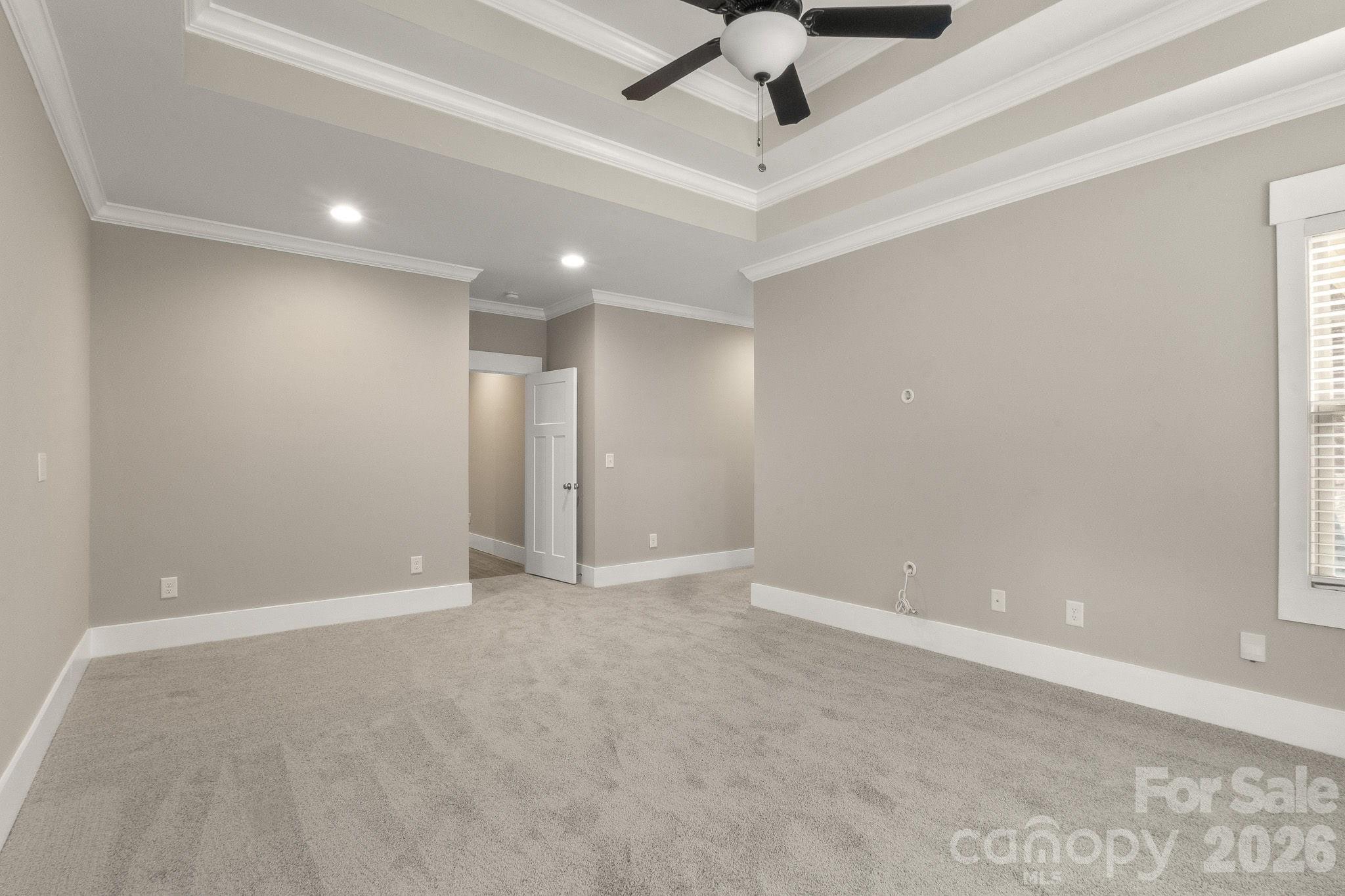 7261 Bay Ridge Drive Denver, NC 28037 - Photo 28 of 48 an empty room with chandelier fan and windows