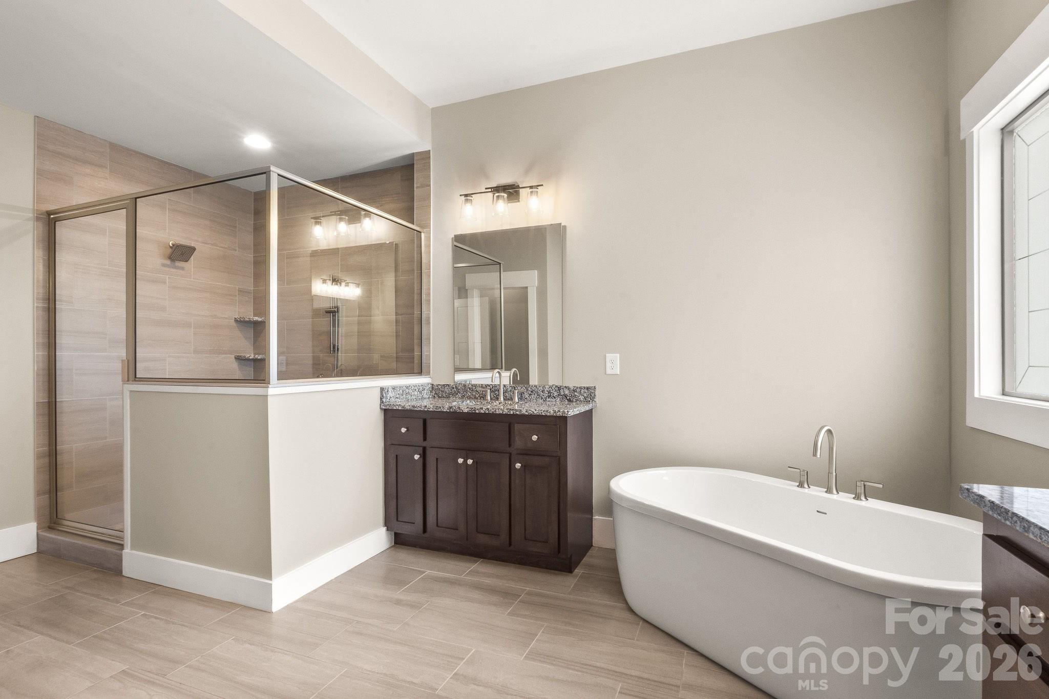 7261 Bay Ridge Drive Denver, NC 28037 - Photo 29 of 48 a spacious bathroom with a tub sink shower and mirror
