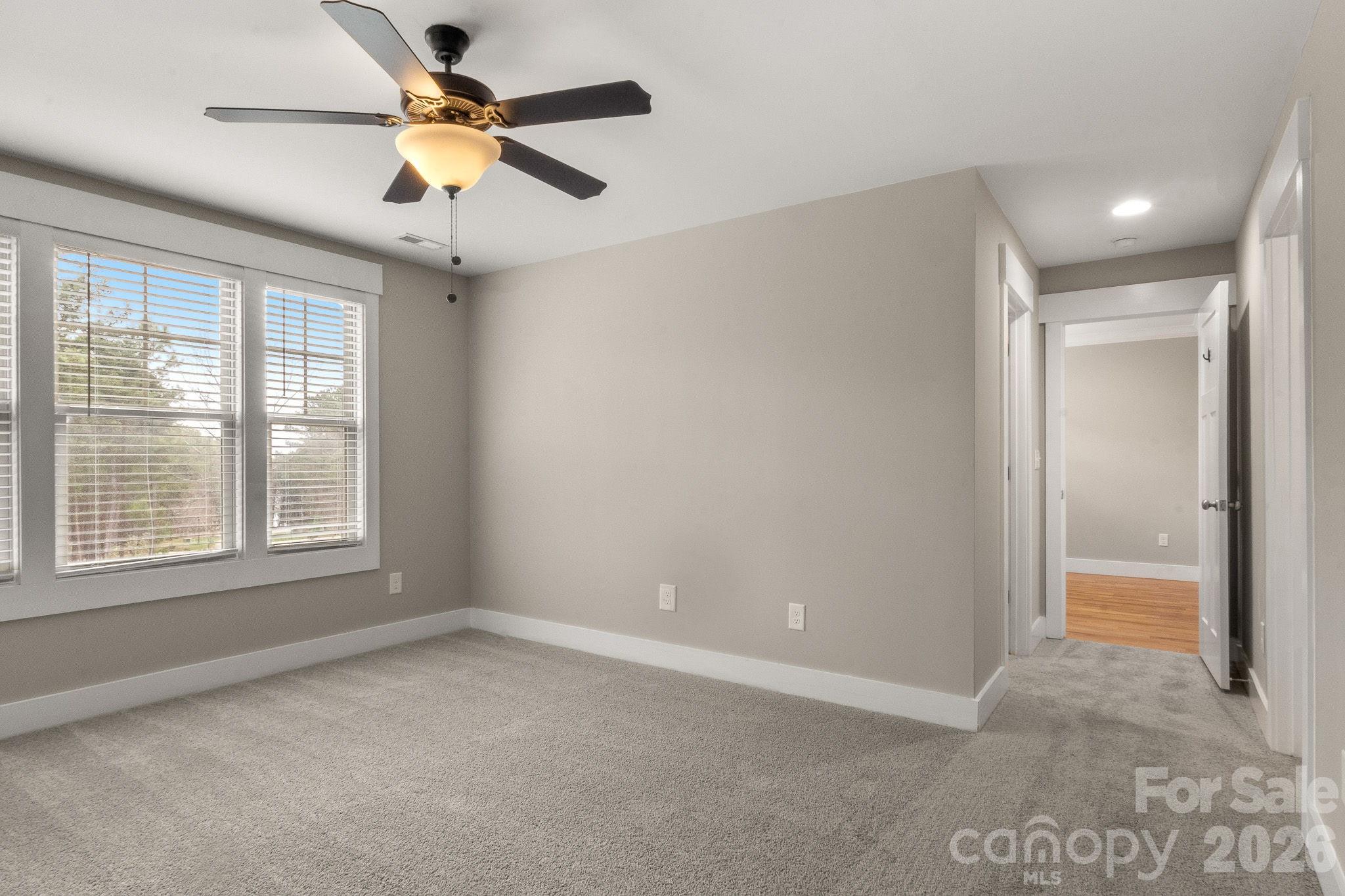 7261 Bay Ridge Drive Denver, NC 28037 - Photo 37 of 48 en empty room with ceiling fan and window