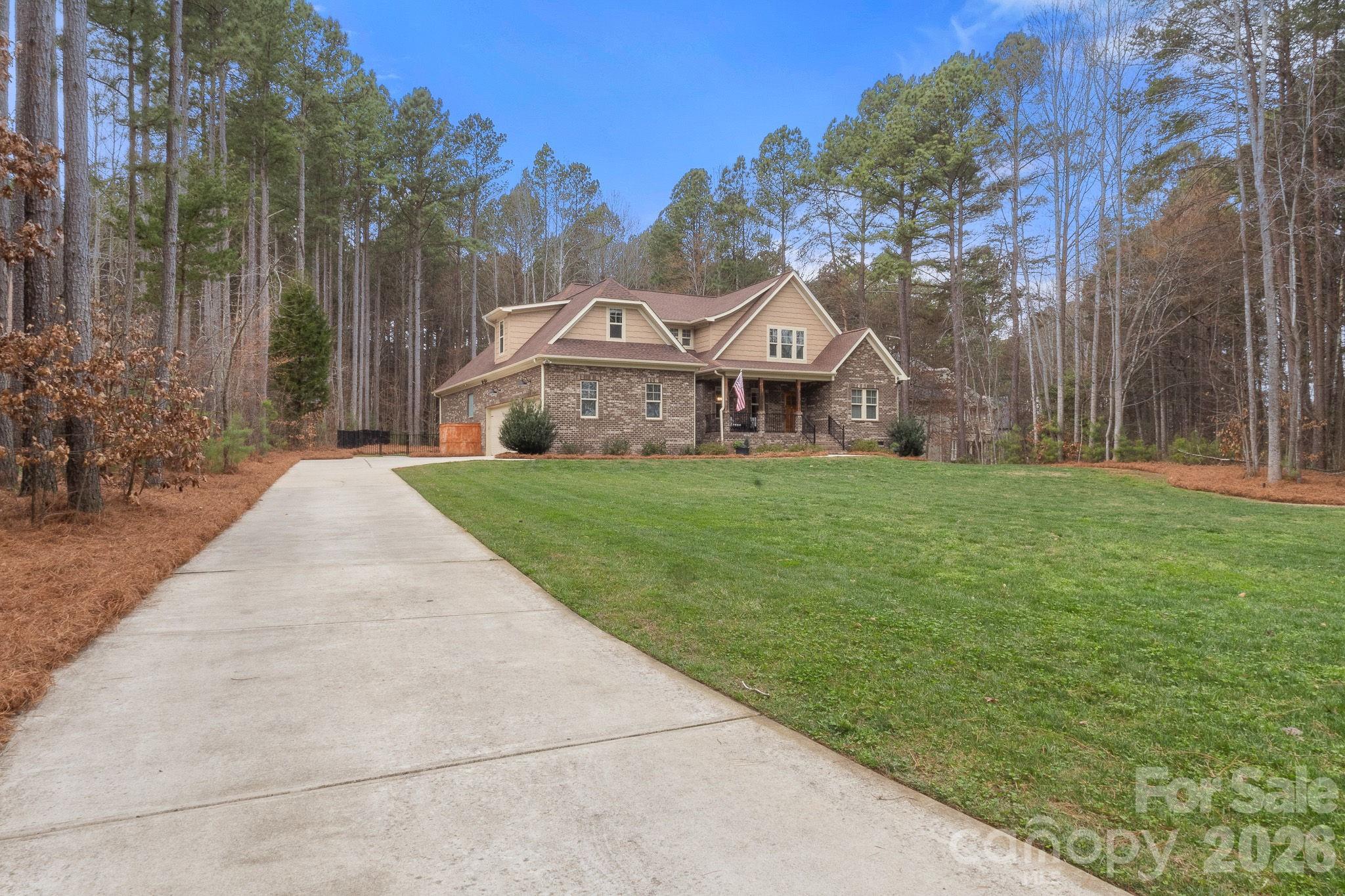 7261 Bay Ridge Drive Denver, NC 28037 - Photo 4 of 48 a front view of a house with a yard and trees