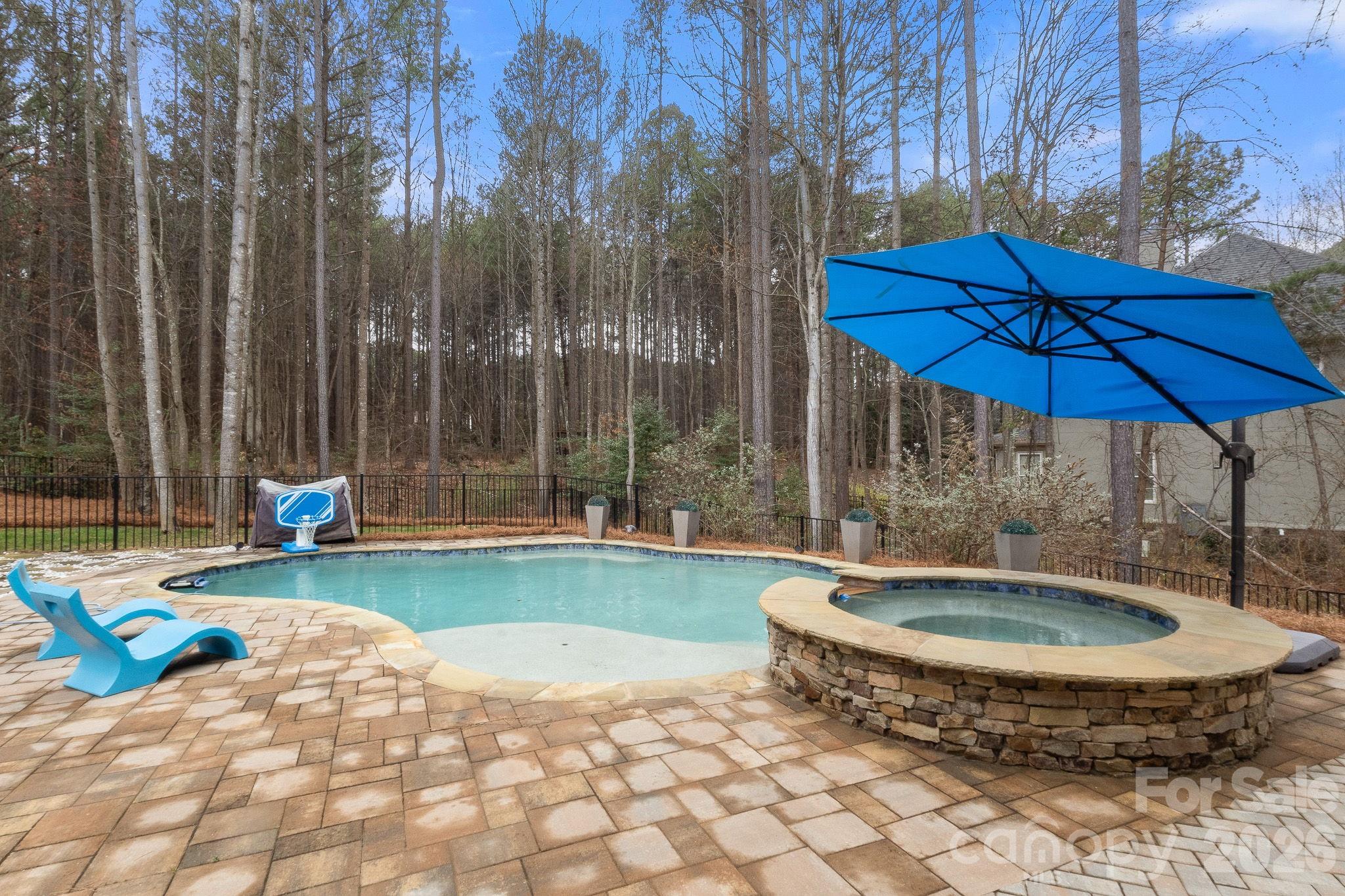 7261 Bay Ridge Drive Denver, NC 28037 - Photo 9 of 48 a view of a backyard with table and chairs under an umbrella