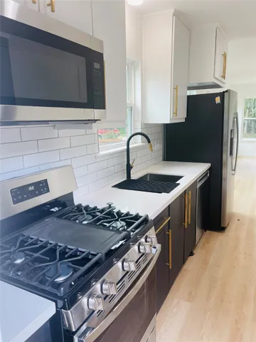 a kitchen with a stove and a microwave