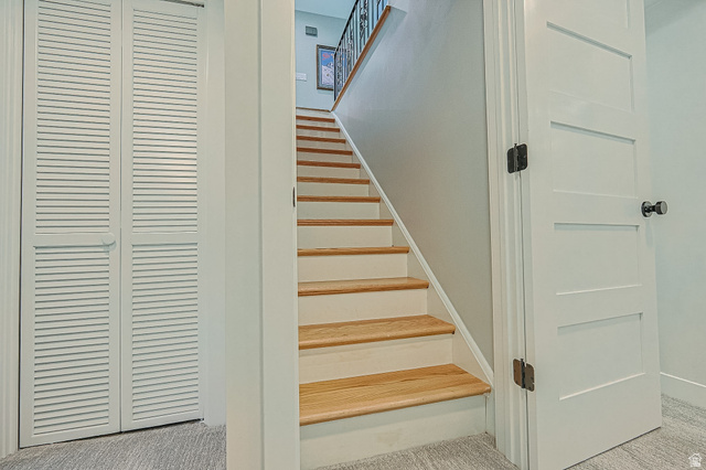2924 Robidoux Road Sandy, UT 84093 - Photo 41 of 68 Hardwood tread staircase with painted risers, louvered bi-fold closet doors, and a four-panel interior door