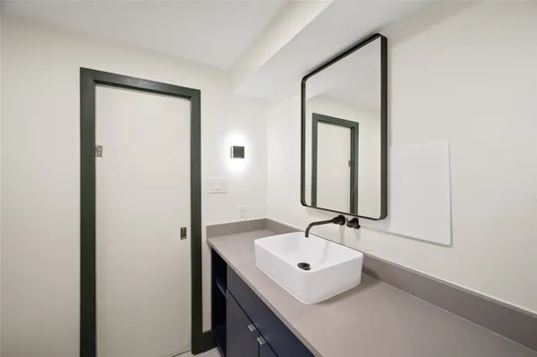 a bathroom with a sink a mirror and a vanity