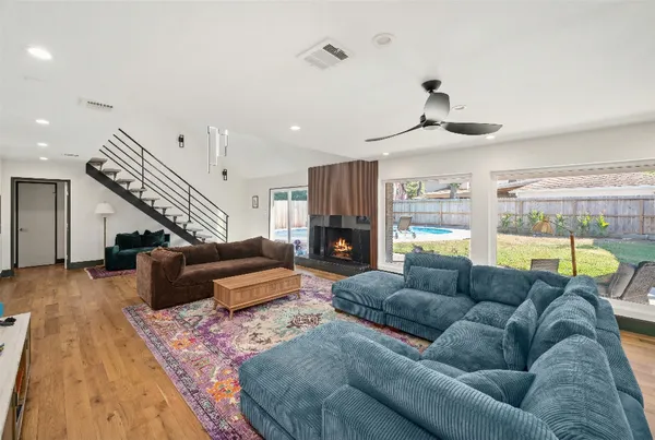 a living room with furniture and wooden floor