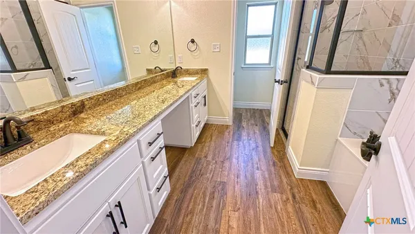 a bath tub sitting in a bathroom next to a sink